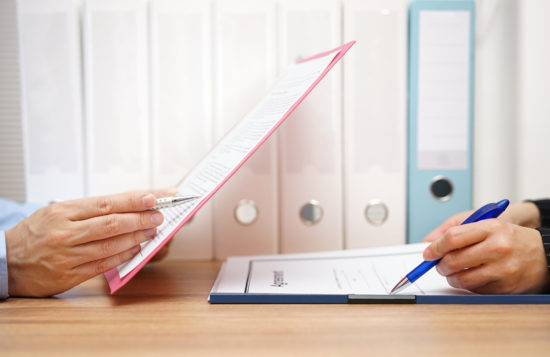 Inspector and auditor are inspecting legal and financial documents